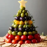 Antipasto Christmas Tree Cheese Ball decorated with herbs and olives