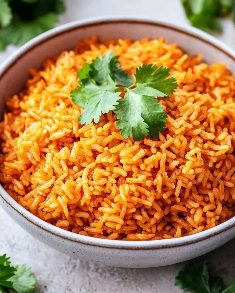 Bowl of easy Mexican rice garnished with cilantro and lime