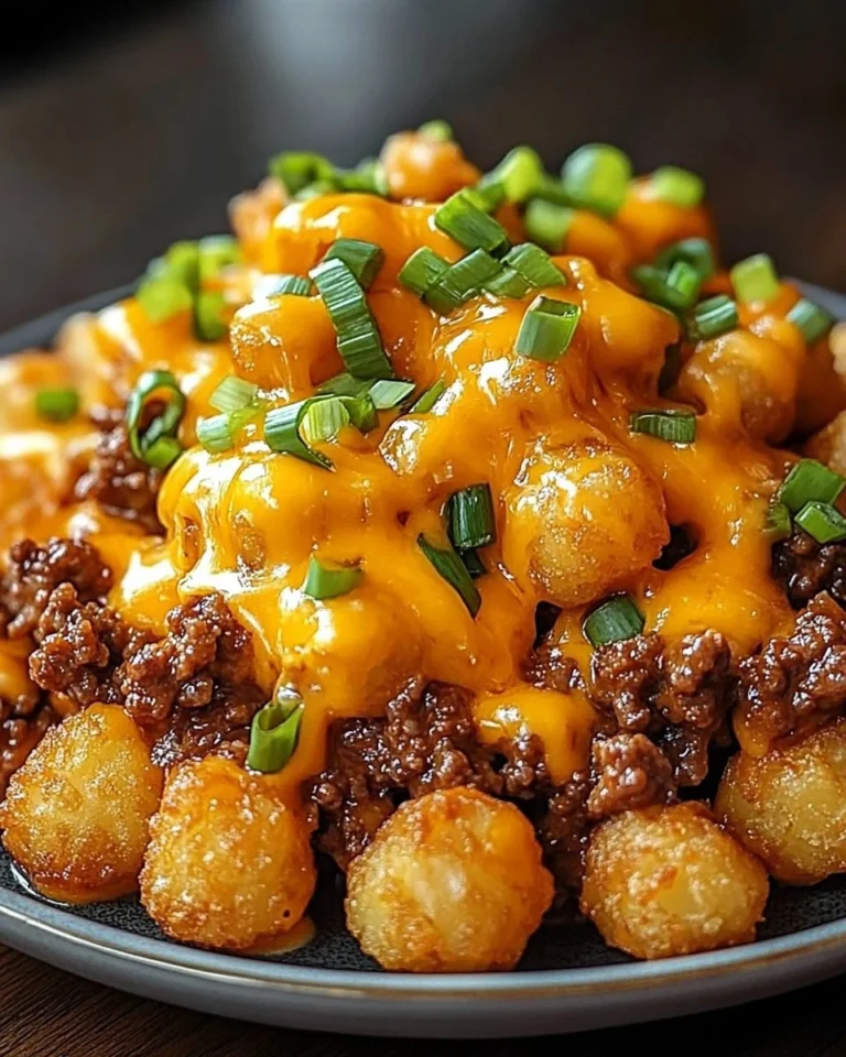 Delicious one-pan cheeseburger tater tot pasta dish garnished with cheese and herbs.