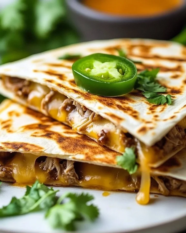 Delicious steak quesadilla with melted cheese and fresh toppings on a plate