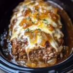 Indulgent Crock Pot French onion meatloaf served on a cozy dinner plate